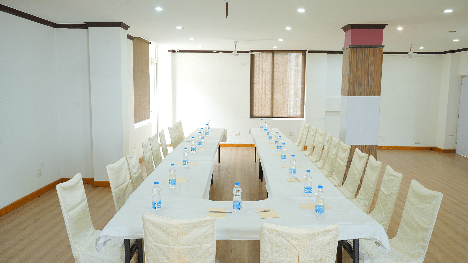 Image of the conference room featuring a large table and several chairs around it | DLS Hotel Shiva Sanctuary and Spa
